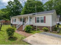 Charming single-story home with a welcoming front porch and well-maintained landscaping at 792 Carolina Mill Cir, Lincolnton, NC 28092