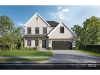 Charming two-story home featuring a white brick facade, dark window trim, and an attached two-car garage at Lot 49 Lavender Ln, Kannapolis, NC 28083