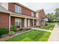 Attractive brick townhouse featuring well-maintained landscaping, a covered porch, and welcoming curb appeal at 102 Brandywine Ne Dr # O-3, Conover, NC 28613