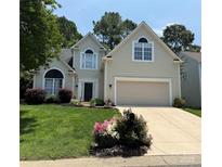 Charming two-story home boasts a manicured lawn and traditional architectural details at 14218 Springsure Ct, Huntersville, NC 28078