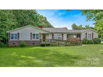 Ranch style home with brick foundation, wood ramp, shutters and a well-manicured lawn at 1435 W Ridge Rd, Salisbury, NC 28147