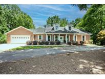 Charming one-story brick home with white trim, dormer windows, and a well-manicured front yard at 169 Wilcox Karriker Ln, Statesville, NC 28625