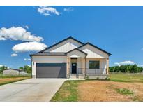 Charming home featuring a modern farmhouse exterior, covered porch, and an attached two-car garage at 2104 County Line Rd, Kings Mountain, NC 28086
