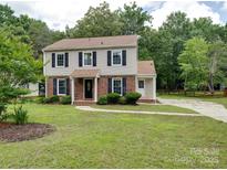 Charming two-story home featuring manicured landscaping and a welcoming walkway at 2240 Lawton Bluff Rd, Charlotte, NC 28226