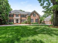 Beautiful two-story brick home with black shutters, white trim and a well-manicured front lawn at 2516 Selwyn Ave, Charlotte, NC 28209