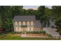 Charming two-story traditional home featuring a landscaped front yard and covered front porch at 29049 Snapper Pt, Tega Cay, SC 29708