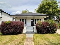 Charming single-story home featuring a cozy front porch and well-maintained landscaping at 306 Sacco St, Belmont, NC 28012