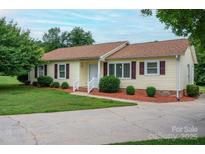 Charming home with a well-manicured front yard, lovely landscaping, and a cozy appeal at 3537 Heather Ln, Gastonia, NC 28056