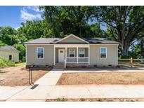 Charming single-story home with a covered front porch, landscaped yard, and inviting curb appeal at 406 N Bostian St, China Grove, NC 28023