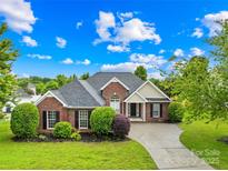 Charming single-story brick home with well-manicured lawn and inviting curb appeal at 4809 Mossy Cup Ln, Monroe, NC 28110