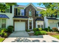 Charming brick townhome featuring a one-car garage and well-maintained landscaping at 513 Pate Dr, Fort Mill, SC 29715