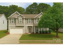 Charming two-story home with a well-manicured lawn and attached two-car garage at 6120 Brightstar Valley Rd, Mint Hill, NC 28227