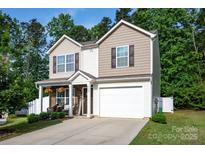Charming two-story home with a manicured lawn and a two-car garage in a quiet neighborhood at 7527 Finnigan Rd, Charlotte, NC 28215