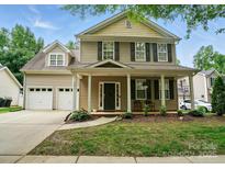 Charming two-story home with a welcoming front porch and well-manicured landscaping at 9856 Caldwell Depot Rd, Cornelius, NC 28031