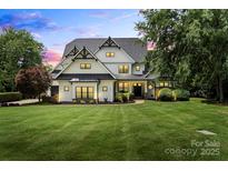 Stunning two-story home with black trim, white siding and lush green lawn at 106 Kent Ct, Mooresville, NC 28117