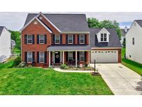 Beautiful two-story brick home with a well-manicured lawn and inviting front porch at 121 Royalton Rd, Mooresville, NC 28115