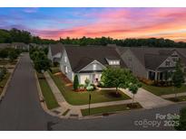Charming home with well-manicured lawn and beautiful sunset in a desirable neighborhood setting at 16034 Rushwick Dr, Huntersville, NC 28078