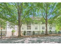 Inviting exterior view of a multi-story condo with mature trees and well-maintained landscaping at 18605 Ruffner Dr # 3E, Cornelius, NC 28031