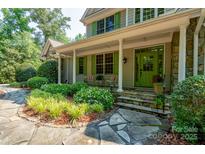 Charming front porch with stone accents, vibrant green door and shutters, and inviting landscape at 258 Patterson'S Bridge None, New London, NC 28127