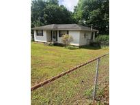 Quaint single-story home featuring a modest front porch and a spacious front yard with chain link fence at 2921 Ambrose Dr, Gastonia, NC 28056