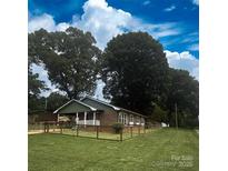 Charming brick home featuring a well-maintained lawn and a classic fenced yard, perfect for families at 300 N Watterson St, Kings Mountain, NC 28086