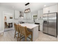 Bright white kitchen featuring stainless steel appliances, a center island, and shaker cabinets at 3615 Kempton Pl, Charlotte, NC 28208