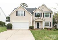 Charming two-story home featuring a two-car garage and a well-maintained lawn at 435 Riverwalk Nw Dv, Concord, NC 28027