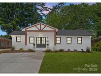 Charming single-story home featuring a brick facade, updated landscaping, and a inviting front porch at 4562 Rockford Ct, Charlotte, NC 28209
