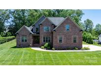 Stunning brick home with well-manicured lawn and mature trees at 73 41St Nw Ave, Hickory, NC 28601