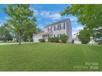 Charming two-story home featuring a well-manicured lawn and inviting curb appeal at 1111 Balcorn Pl, Charlotte, NC 28214