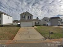 Charming two-story home with a two car garage, and a traditional suburban landscape at 1540 Hollow Maple Dr # 122, Charlotte, NC 28216