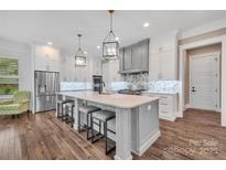 Bright kitchen with large island, stainless steel appliances, and hardwood flooring at 1622 Hunters Place Rd, York, SC 29745