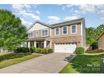 Beautiful two-story home boasts a combination of siding, brick, and a meticulously maintained front yard at 1905 Yellow Daisy Dr, Matthews, NC 28104