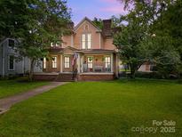 Charming two-story home with a welcoming front porch and lush green lawn at 217 S Ellis St, Salisbury, NC 28144