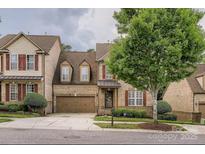 Charming brick home with an attached garage, landscaped yard, and a welcoming entrance at 2234 Donnington Nw Ln, Concord, NC 28027