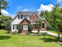 Charming two-story home with a well-manicured lawn, brick and siding exterior, and a delightful garden at 2325 Perry Rd, Denver, NC 28037