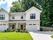 Charming two-story home with white siding, black framed windows, and an attached one car garage at 2517 Marlowe Ave, Charlotte, NC 28208
