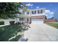 Charming two-story home with a well-manicured lawn and a two-car garage in a Gathering-friendly neighborhood at 3015 Liddington Rd, Matthews, NC 28105