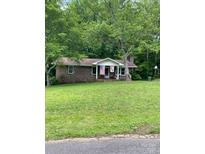Charming brick home with American flag and spacious front yard at 31 Southbrook Dr, York, SC 29745