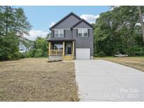 Charming two-story home with a combination front porch and attached garage at 401 W Charlotte Ave, Mount Holly, NC 28120