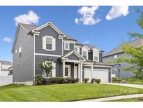 Beautiful two-story home featuring gray siding, white trim, and a well-manicured front yard at 4029 Spring Garden St, Fort Mill, SC 29715