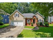 Charming home featuring a two-car garage and manicured landscaping at 4612 Saxonbury Way, Charlotte, NC 28269