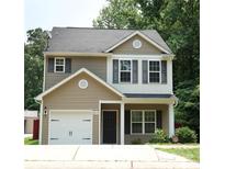 Charming two-story home with a well-maintained front yard and attached garage with black fixtures at 6919 Ware Rd, Charlotte, NC 28212