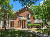 Charming brick townhome with well-maintained lawn and inviting entryway, perfect for comfortable living at 9404 S Vicksburg Park Ct, Charlotte, NC 28210
