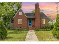Charming brick home with a striking blue front door and a well-manicured lawn at 1400 Matheson Ave, Charlotte, NC 28205