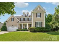 Charming two-story home with a well-manicured lawn and inviting curb appeal at 1805 Sutter Creek Dr, Waxhaw, NC 28173