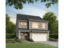 Charming two-story home featuring a two-car garage, well-manicured lawn, and desirable curb appeal at 2027 Sadler Woods Ln, Charlotte, NC 28214