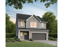 Charming two-story home boasts manicured lawn and two-car garage at 2031 Sadler Woods Ln, Charlotte, NC 28214