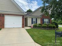 Charming single-story home boasts manicured lawn, brick accents, and attached garage for comfortable suburban living at 204 Woodbridge Cir, Mount Holly, NC 28120