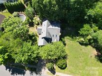 An aerial view of a house surrounded by trees and a swimming pool in the backyard at 20807 Willow Pond Rd, Cornelius, NC 28031